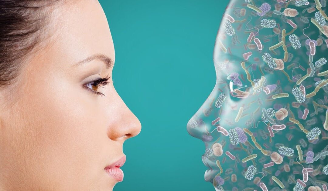 Profile of a woman beside a transparent face with microbes.